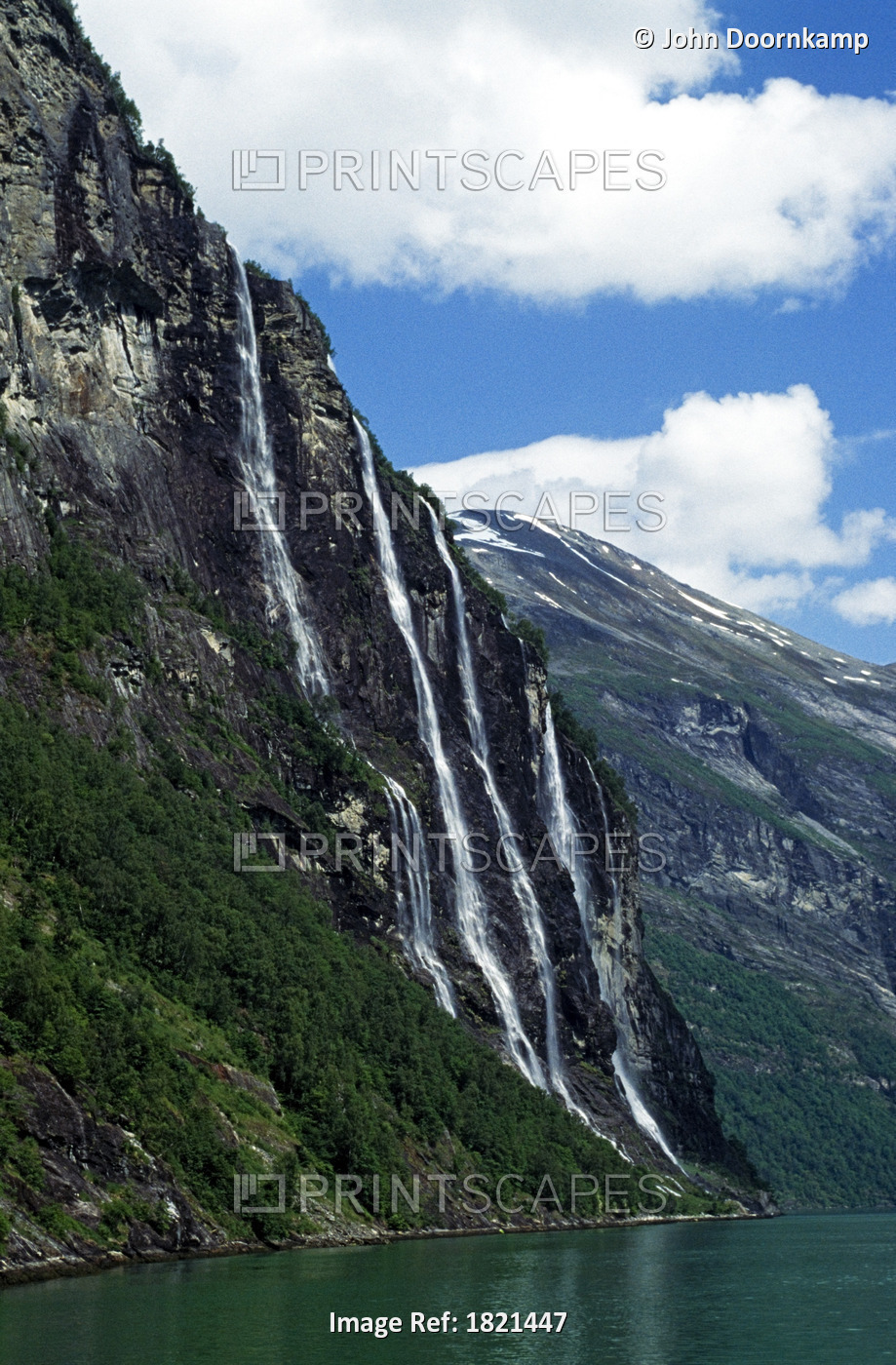 WATERFALLS DOWN A CLIFF FACE  INTO WATER BELOW, LYSEFJORD, NORWAY