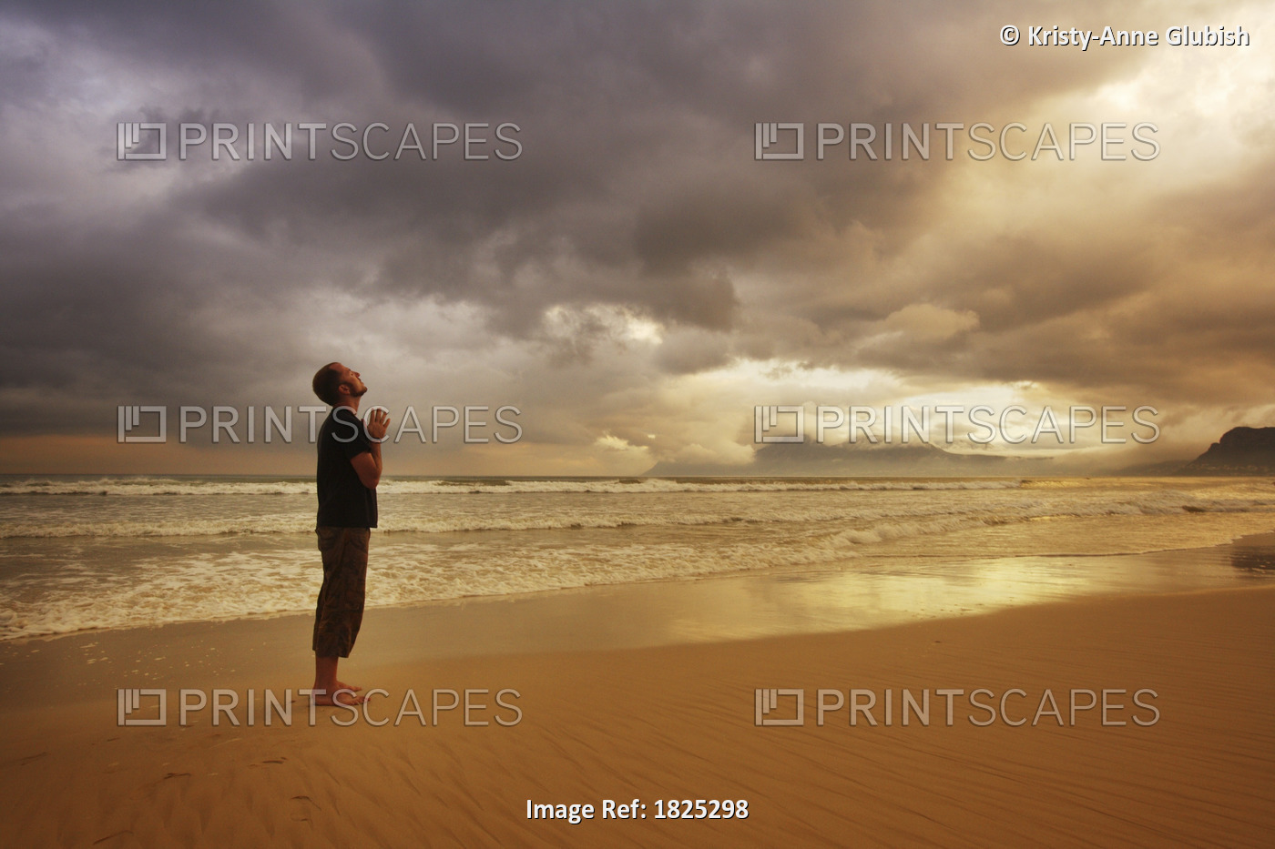 Man Praying On A Beach
