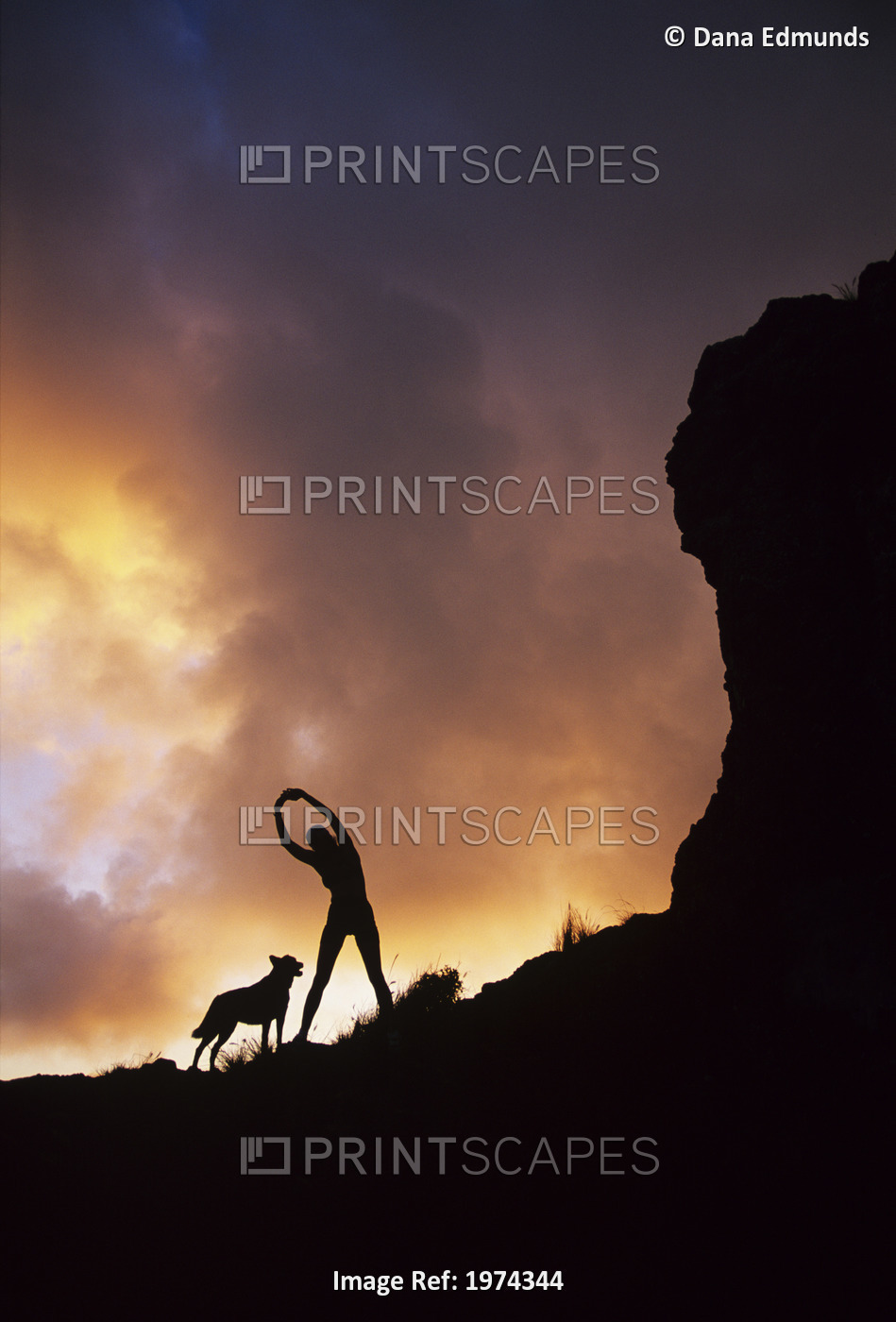 Hawaii, Silhouette Of A Woman Stretching On A Mountain Top At Sunset.