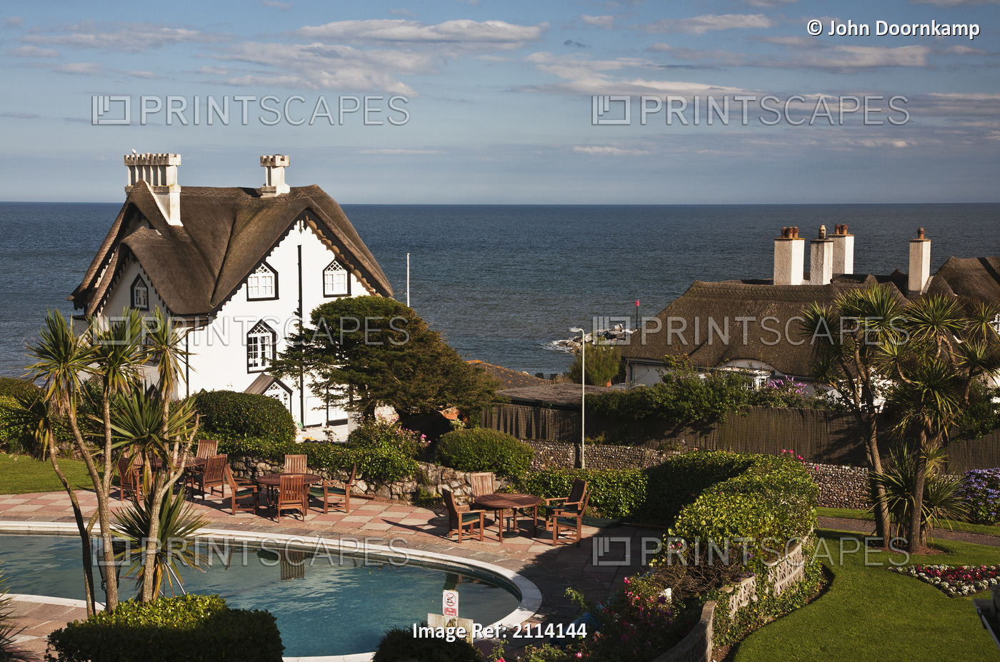 Thatched Cottages And A Swimming Pool Along The Ocean; Sidmouth, Devon, England