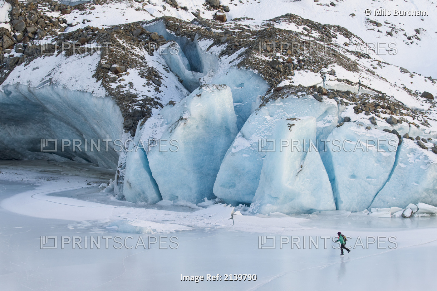 Woman Ice Skating In Front Of Saddlebag Glacier, Chugach Mountains Near ...