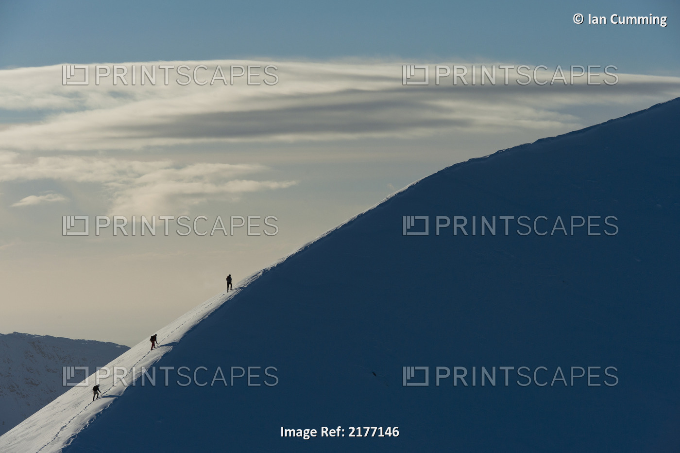 UK, Scotland, Walkers climbing snowy ridge of Sgorr Dhearg in winter near Glen ...