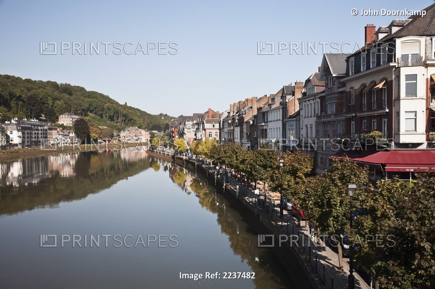 Trees And Buildings Reflected In The Tranquil River Meuse; Dinant, Namur, Belgium