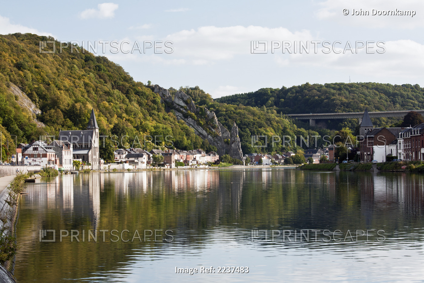 Trees And Buildings Reflected In The Tranquil River Meuse; Dinant Namur Belgium