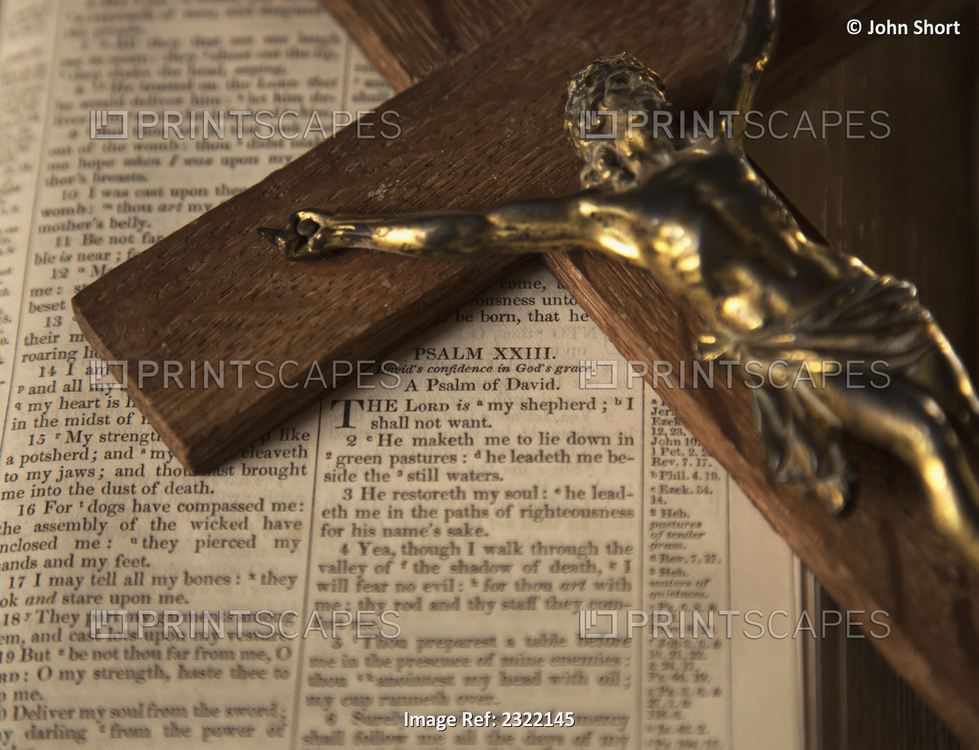Wooden crucifix laying on open Bible; Yetholm, Scottish Borders, Scotland, UK
