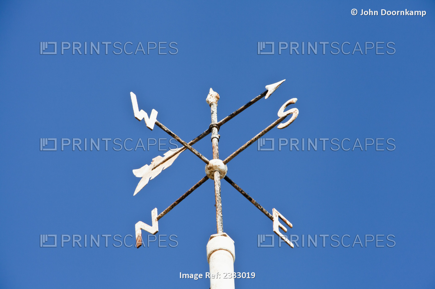 Weather Vane Against A Blue Sky; England
