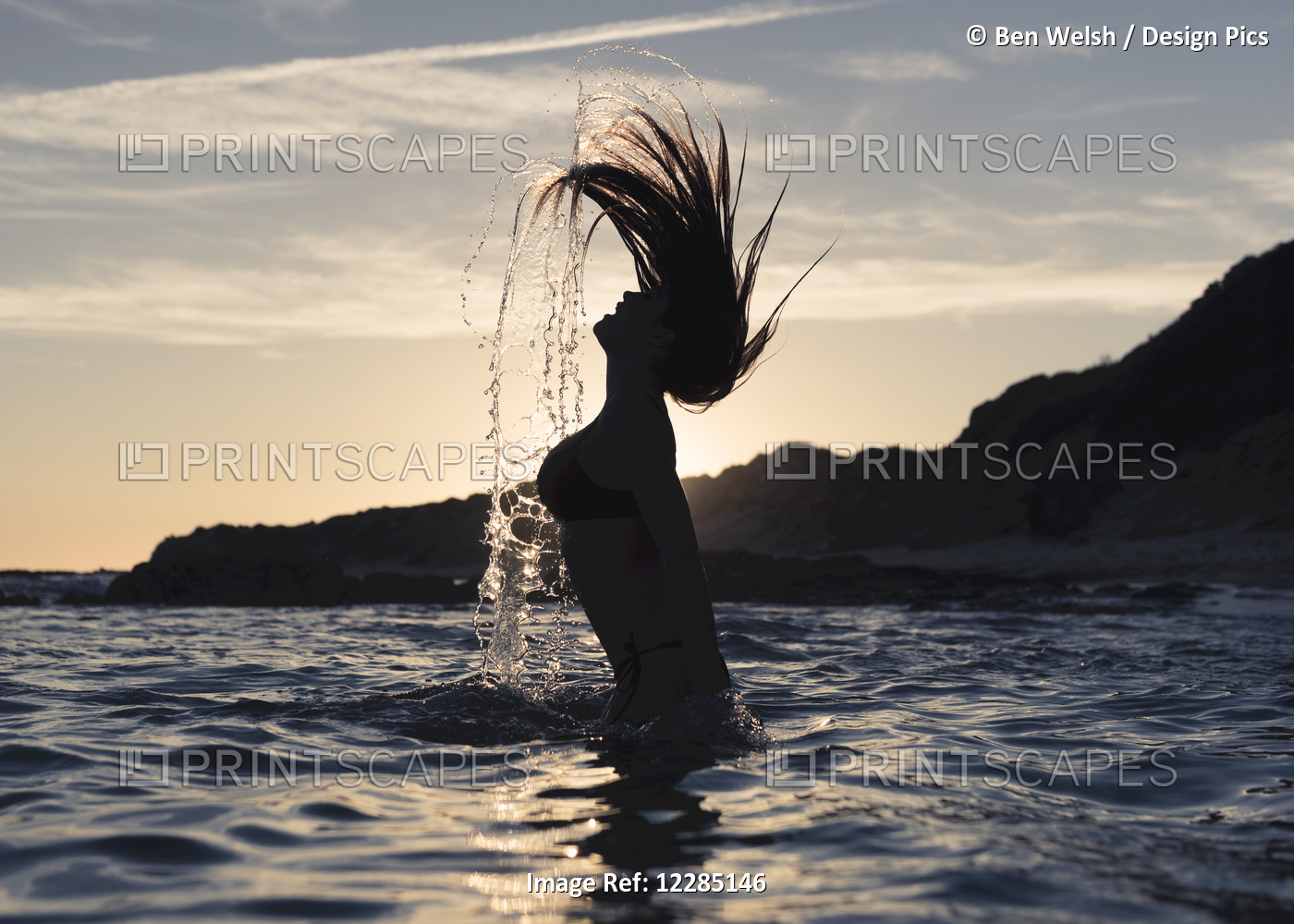 Silhouette Of A Woman In Waist-Deep Water Flipping Her Wet Long Hair Up In The ...