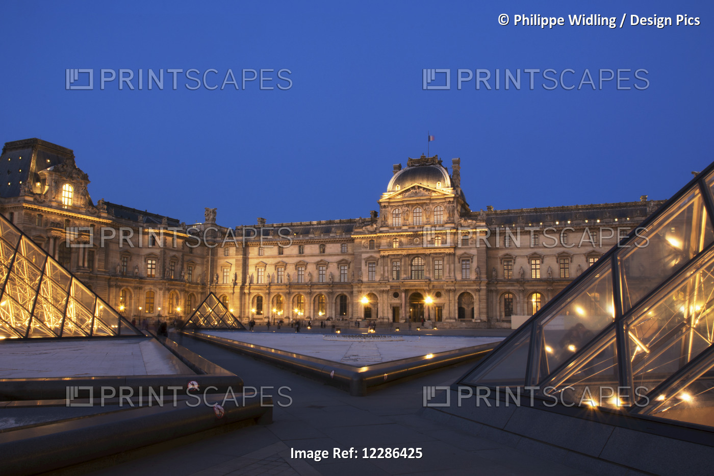 Le Louvre Palace Buildings And Pyramids At Night In Golden Light; Paris, France