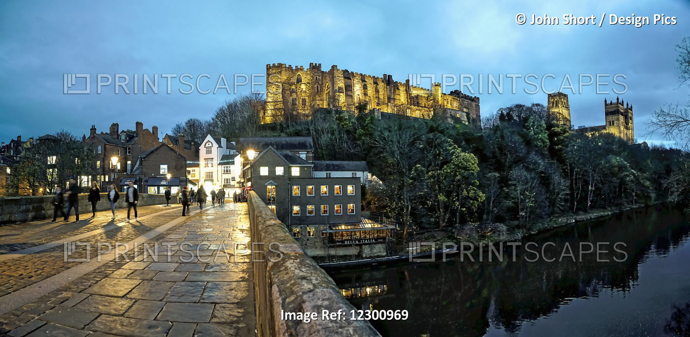 Pedestrians Walking On A Walkway Over A River At Dusk With Durham Cathedral And ...