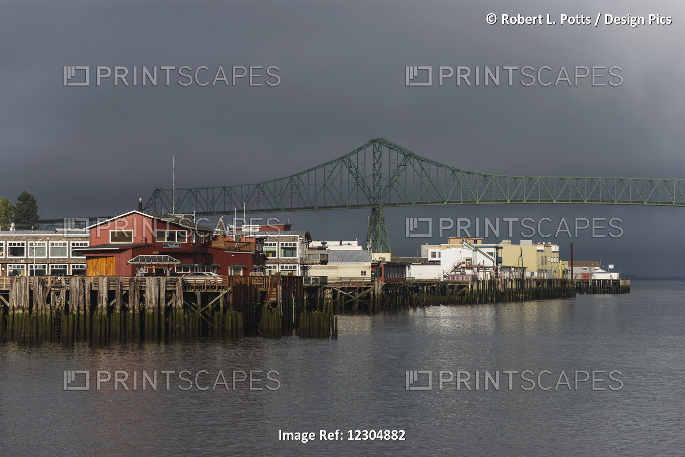 Sunlight Warms The Riverfront With Storm Clouds Over The Astoria-Megler Bridge; ...
