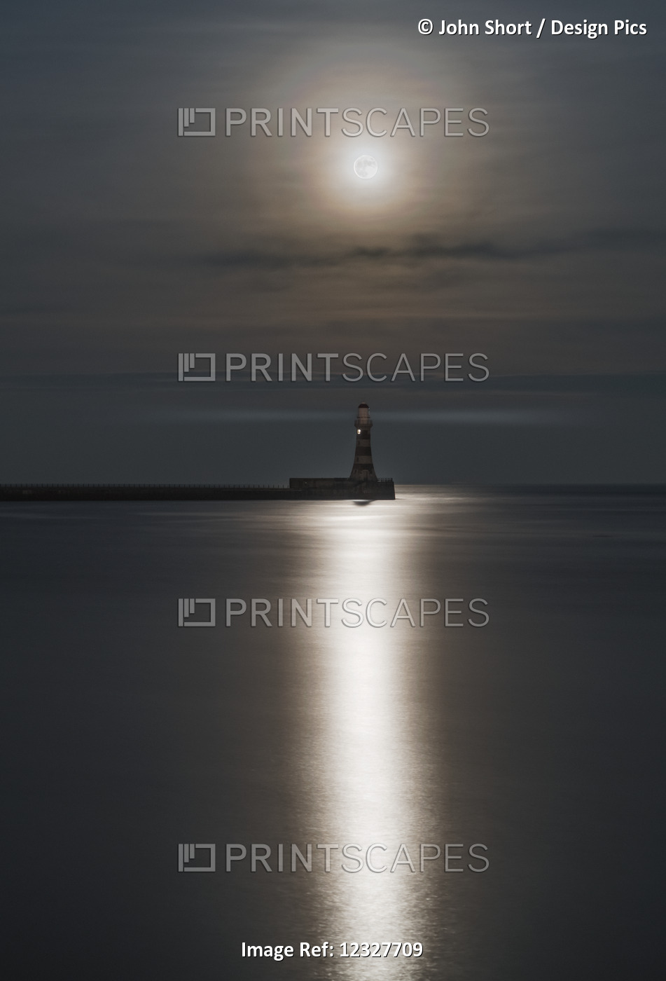 Roker Lighthouse At The End Of A Pier Under A Bright Full Moon Reflecting On ...