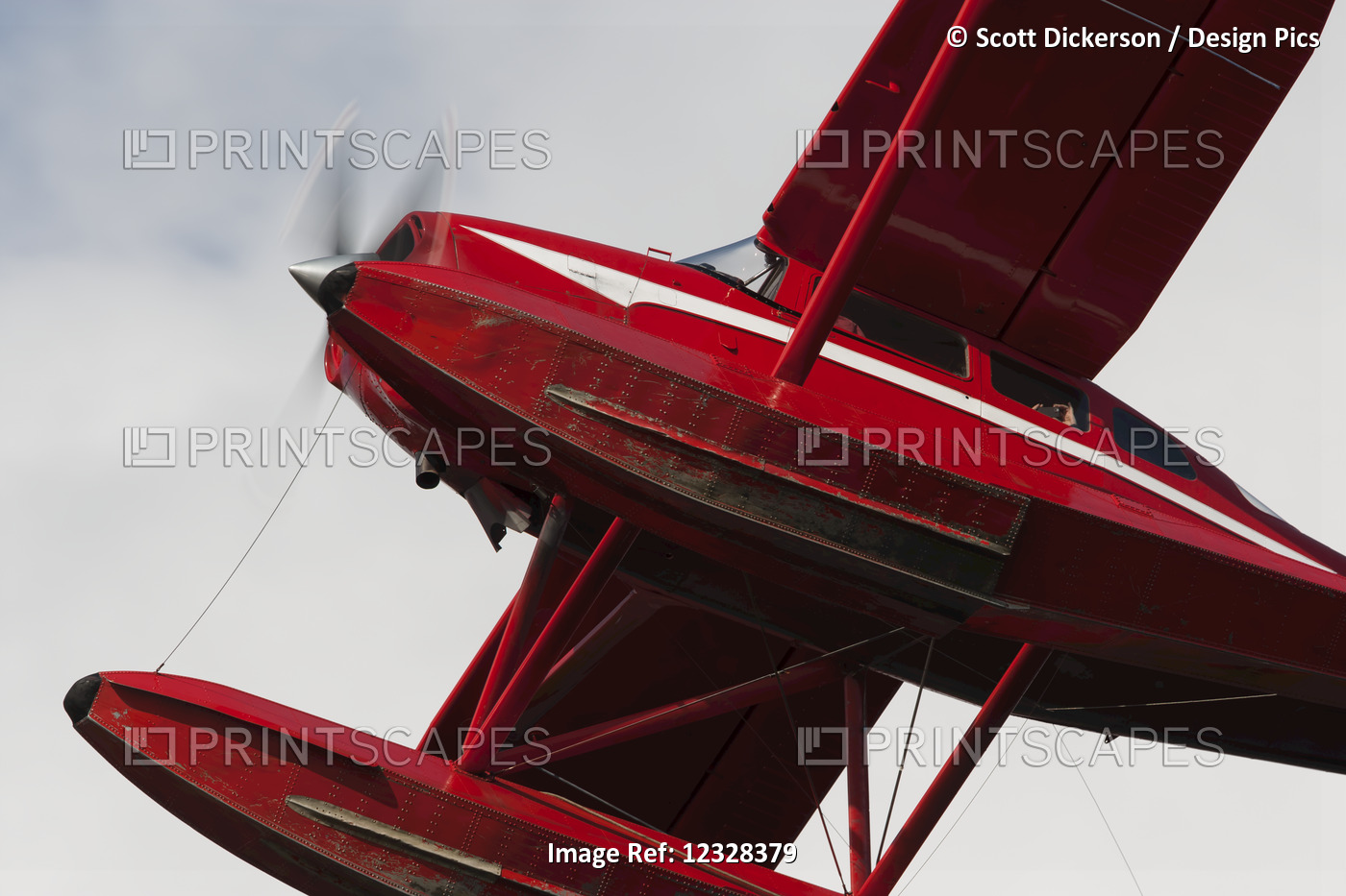 Low Angle View Of A Red Float Plane Against A Cloudy Sky; Alaska, United States ...