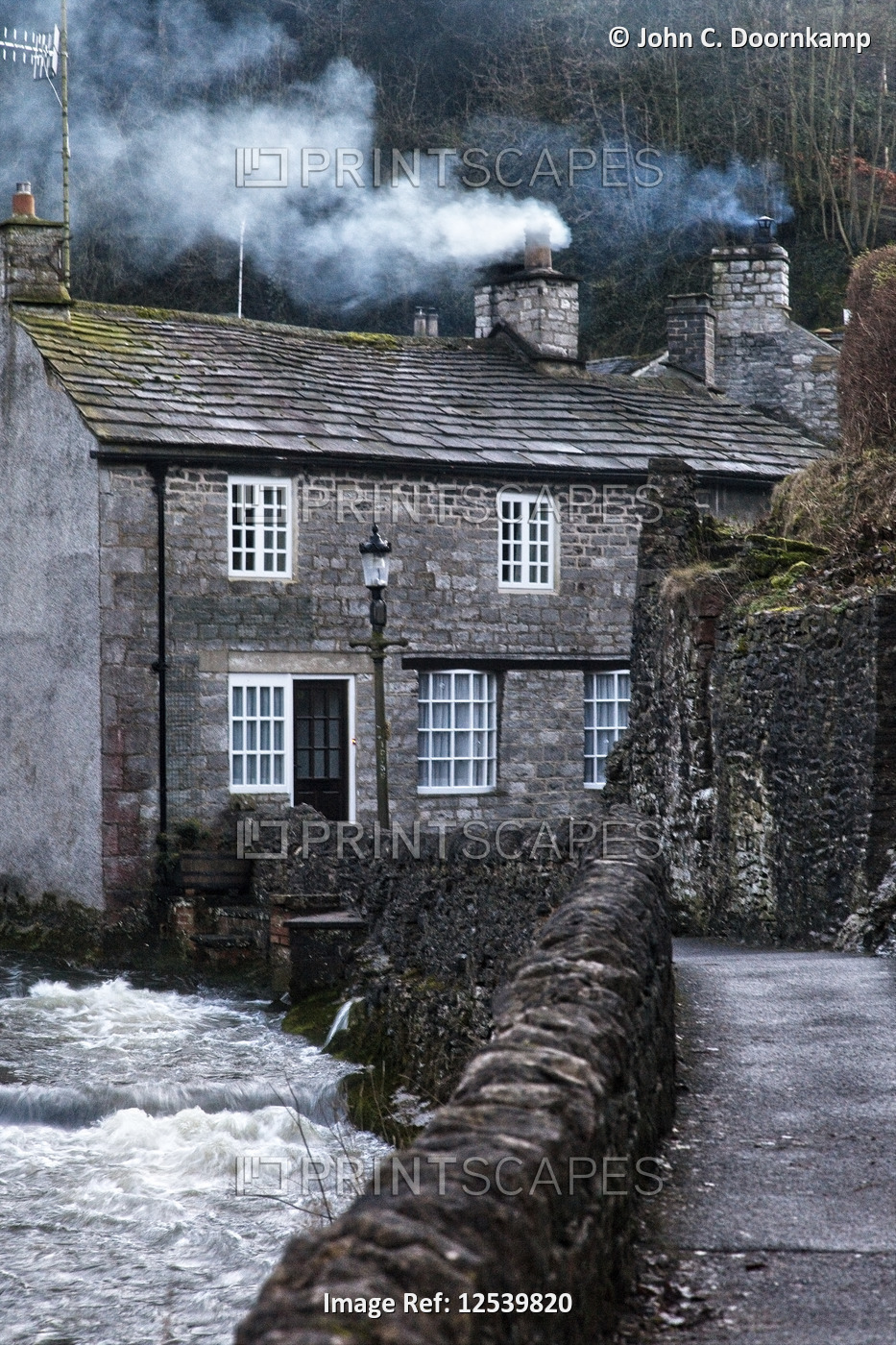 URBAN SCENE OF A GREY STONE HOUSE WITH SMOKE COMING FROM ITS CHIMNEY