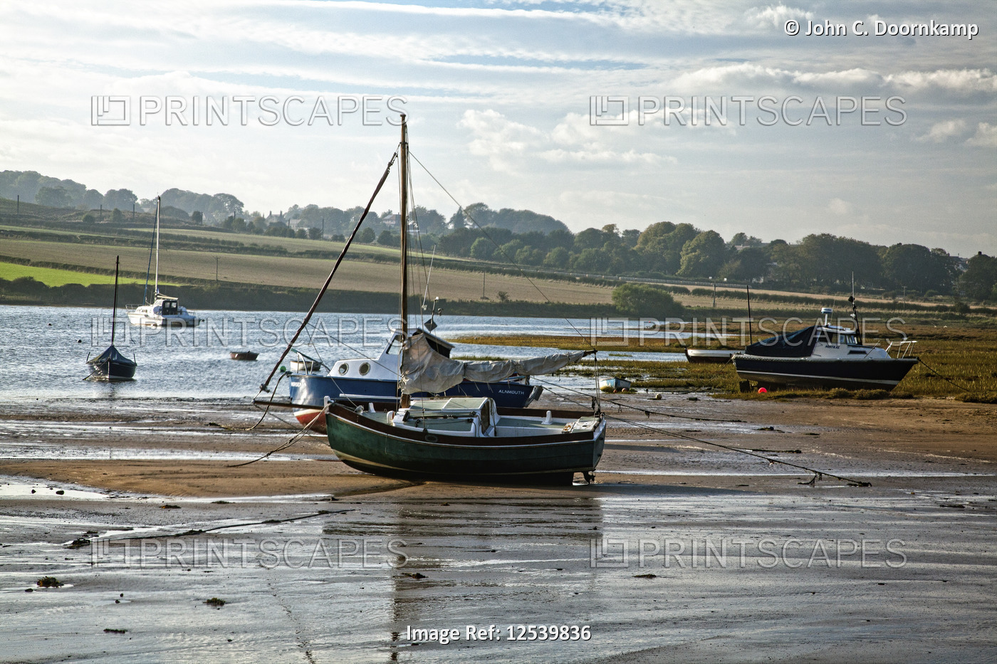 BOATS BEACHED BY THE LOW TIDE IN THE ALNMOUTH ESTUARY, ENGLAND