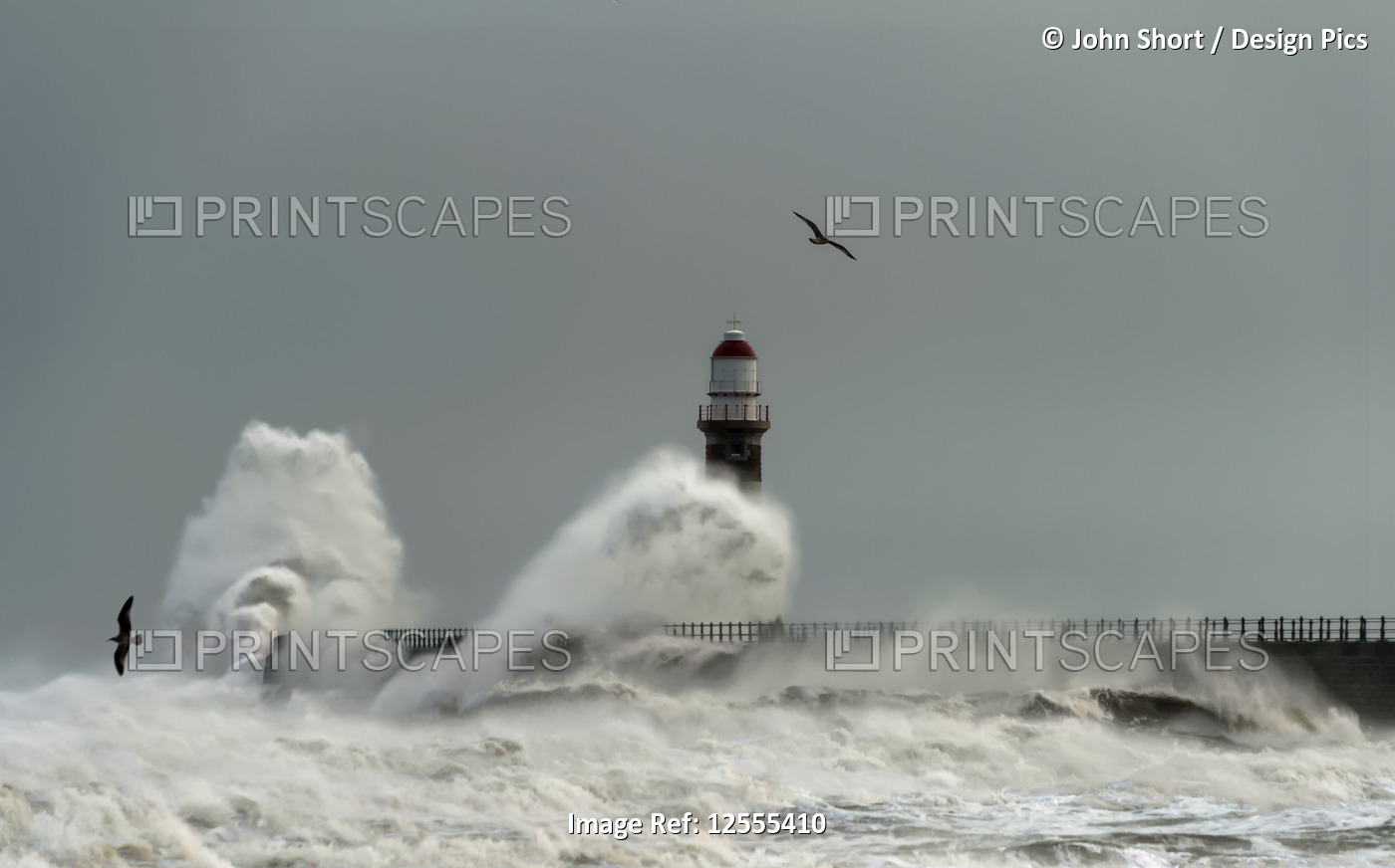 Roker Lighthouse and waves from the River Ware crashing onto the pier; ...