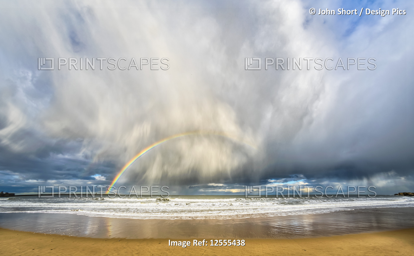 Rainbow through storm clouds viewed from a beach; South Shields, Tyne and Wear, ...