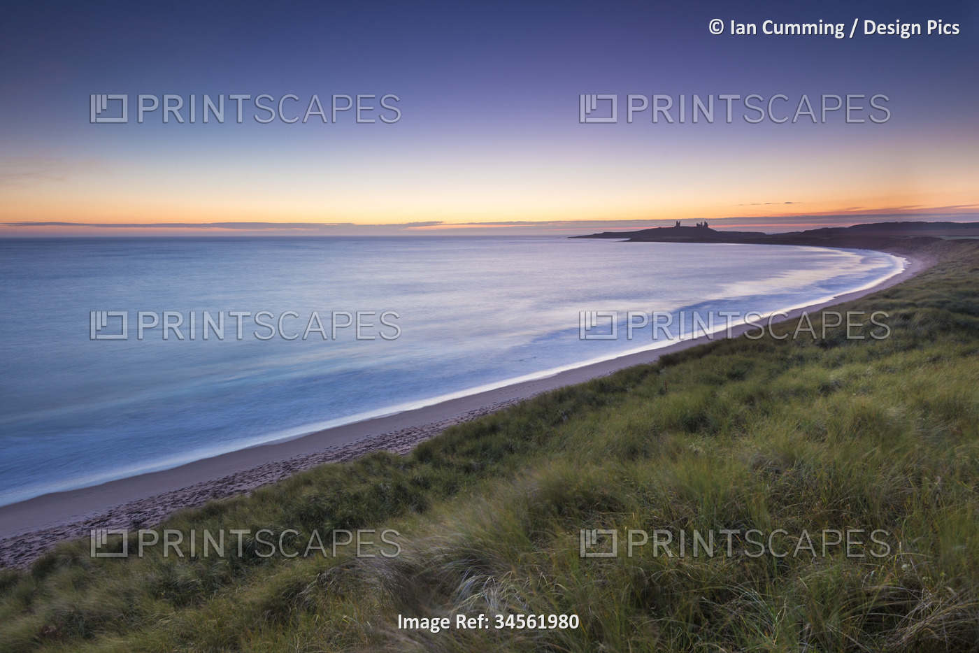 Embleton Beach at dawn with Dunstanburgh Castle in the distance; ...