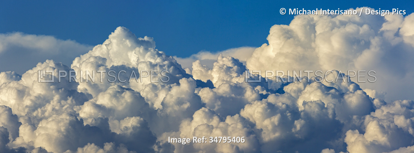 Panorama of dramatic storm clouds with blue sky; Calgary, Alberta, Canada